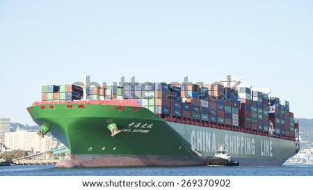 OAKLAND, CA - APRIL 12, 2015: China Shipping Line Cargo Ship CSCL AUTUMN departing the Port of Oakland. The Port of Oakland is the fifth busiest container port in the United States.
