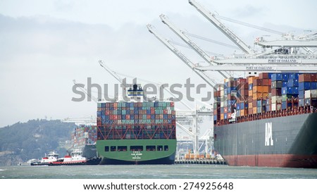 OAKLAND, CA - MAY 03, 2015: China Shipping Lines Cargo Ship CSCL SPRING entering the Port of Oakland. Tugboats push the vessel sideways to the dock.