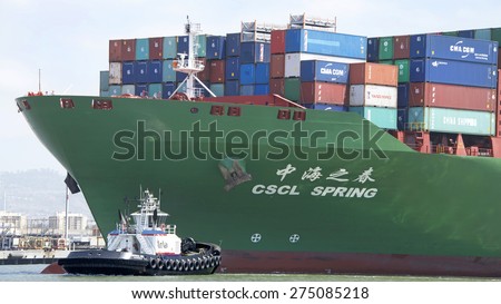 OAKLAND, CA - MAY 03, 2015: China Shipping Lines Cargo Ship CSCL SPRING entering the Port of Oakland  with Tugboat PATRICIA ANN assisting from the Port Bow.