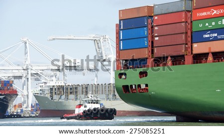 OAKLAND, CA - MAY 03, 2015: China Shipping Lines Cargo Ship CSCL SPRING entering the Port of Oakland with Tugboat VALOR assisting from the stern