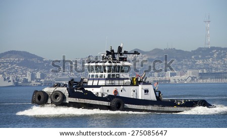 OAKLAND, CA - APRIL 27, 2015: Tugboat Z-FIVE heading towards the Port of Oakland. Tugs move vessels that should not move themselves, such as ships in a crowded harbor.