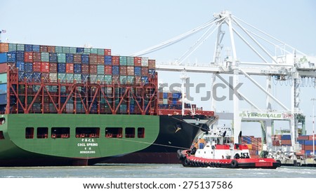 OAKLAND, CA - MAY 03, 2015: China Shipping Lines Cargo Ship CSCL SPRING entering the Port of Oakland with Tugboat VALOR at the stern.