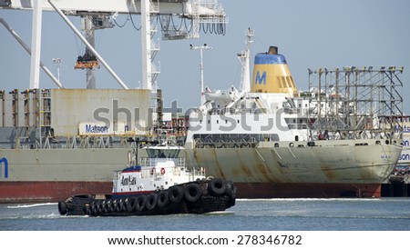 OAKLAND, CA - MAY 06, 2015: AmNav Tugboat LIBERTY at the Port of Oakland. American Navigation was a pioneer in developing tugboats with high horsepower engines in relatively small hulls.