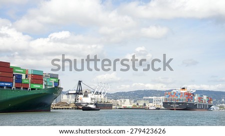 OAKLAND, CA - MAY 13, 2015: Cargo Ship HANJIN BUDDAH entering the Port of Oakland, backs up to allow EVER LIBRA room to turn in the Middle Harbor during departure.