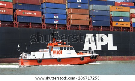 OAKLAND, CA - JUNE 04, 2015: Pilot vessel GOLDEN GATE approaching APL DUBLIN to pick up the harbor pilot as the vessel departs the Port of Oakland.