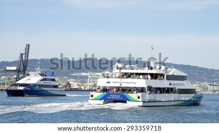 OAKLAND, CA - JUNE 30, 2015: San Francisco Bay Ferry PERALTA passing TAURUS as the vessels transport passengers from Pier 39 and the Port of San Francisco to Alameda and Oakland.