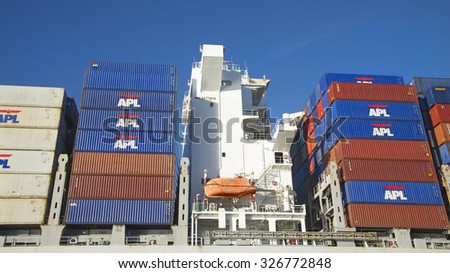 OAKLAND, CA - OCTOBER 10, 2015: Shipping Containers loaded onto Orient Overseas Container Line Cargo Ship OOCL BEIJING  are organized and placed algorithmically for efficient transport.