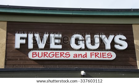 ALAMEDA, CALIFORNIA - NOVEMBER 09, 2015: Five Guys Burgers and Fries restaurant sign. Five Guys is a restaurant chain that serves on hamburgers, hot dogs, and French fries.