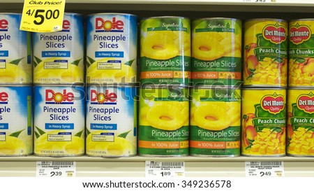 ALAMEDA, CA - DECEMBER 04, 2015: Cans of Dole Pineapple slices next to Signature Kitchens Pineapple slices and Del Monte Peach Chunks on the shelf in a supermarket