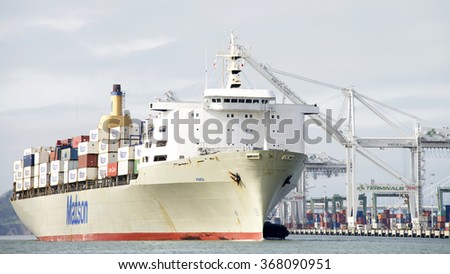 OAKLAND, CA - JANUARY 25, 2016: Cargo Ship MANOA entering the Port of Oakland. The cargo volume at the  Port of Oakland makes it the fifth busiest container port in the United States.