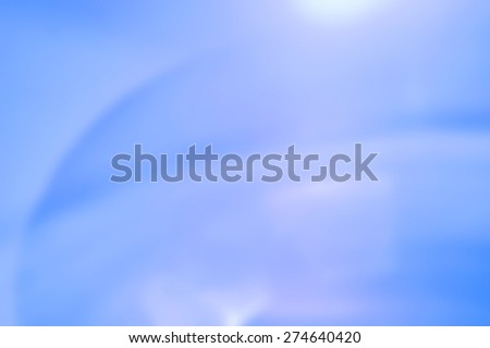 Blurred light blue and white electric fan background scene.