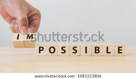 Hand flip wooden cube with word impossible to possible, Personal development and career growth or change yourself concept