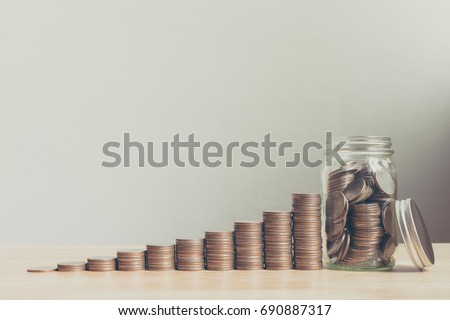 Coin in glass bottle with money stack step up growing growth saving money, Concept financial business investment, Copy space for your text