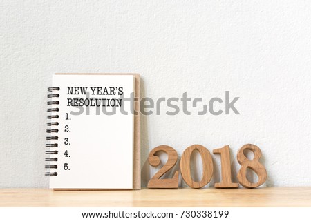 New year\'s resolution on a notebook and wood number 2018 on wood table, Copy space
