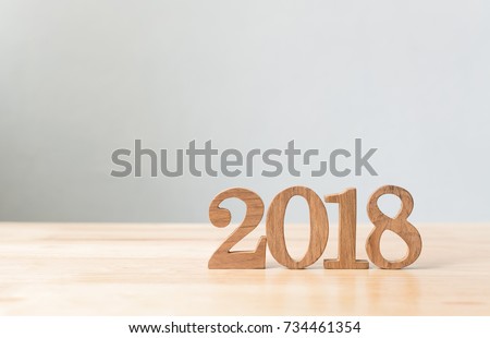Happy new year 2018, Number wood material on wooden table with white wall background, Copy space