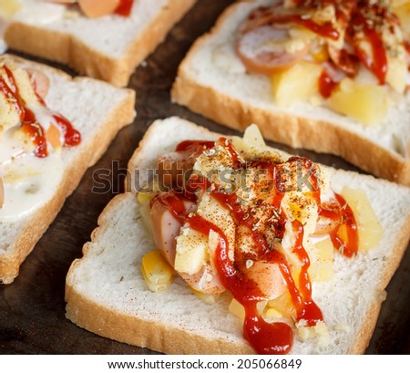 sliced bread with sausage, pineapple and cheese