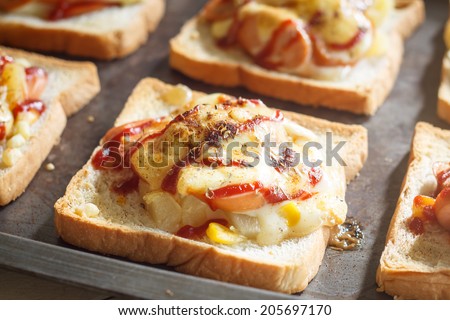 sliced bread with sausage, pineapple and cheese