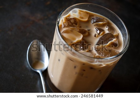 Glass Of Cold Iced Coffee On grunge tray, image dark tone