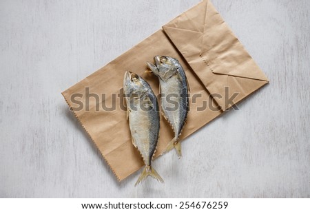 Fresh mackerel or tuna steamed fish put on paper bag
