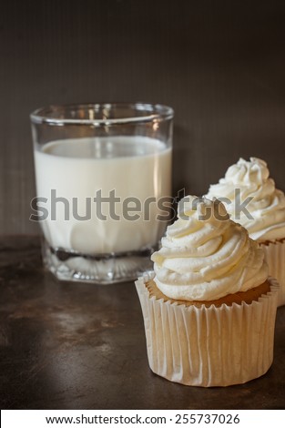 vanilla sweet cupcake with italian butter cream put on grunge tray with spoon , image dark tone