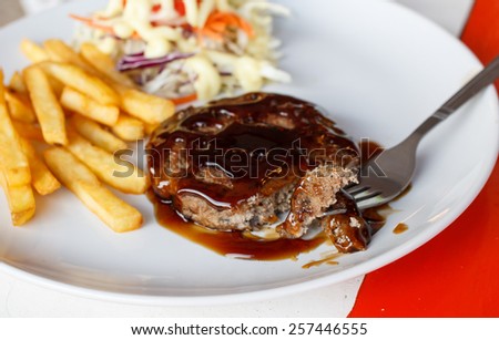 Grilled steaks, French fries and vegetables