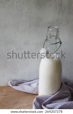 fresh milk in bottle put on vintage white wood
