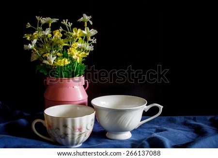 Flower in a pink vase and vintage cup of coffee, cozy home rustic decor, cottage living, still life image dark tone