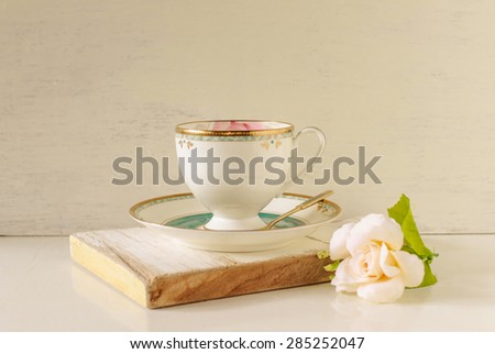 vintage cup coffee on woodden board with flower, image soft tone and soft focus.