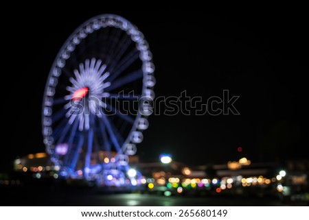 Blurred light of ferris wheel in Bangkok , Thailand - Blurred defocused night lights