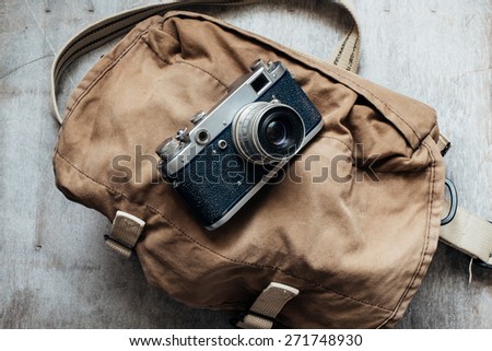 Old camera in bag, vintage photo grunge lighting version design component
