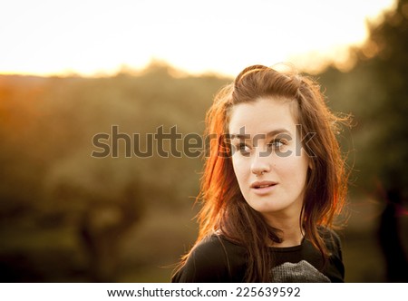 Portrait of red haired girl. Back light.