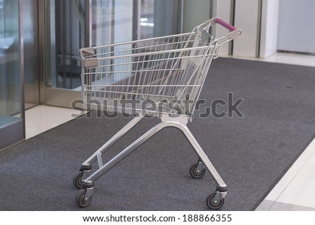 A shopping cart in the mall elevator.