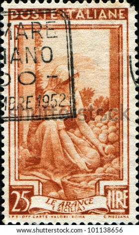 ITALY - CIRCA 1957: A stamp printed in Italy shows woman from Sicilia puts fruit in the basket, circa 1957