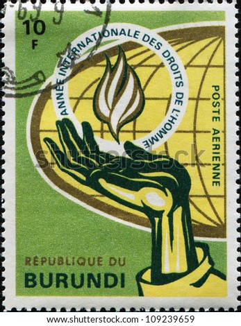 BURUNDI - CIRCA 1969: A stamp printed in Bururndi honoring Human Rights Year, shows Hand holding Flame, circa 1969