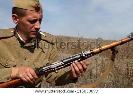 LISICHANSK -SEPT 30 : soldier with gun - member of Lugansk history club wear historical Soviet uniform during historical reenactment of WWII, September 30, 2012 in Lisichansk, Lugansk Region, Ukraine