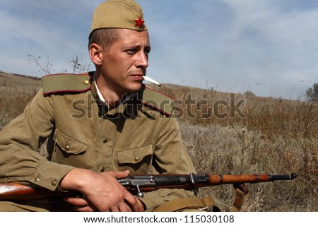 LISICHANSK -SEPT 30 : soldier with gun - member of Lugansk history club wear historical Soviet uniform during historical reenactment of WWII, September 30, 2012, Lisichansk, Lugansk Region, Ukraine