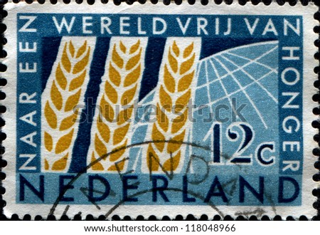 NETHERLANDS - CIRCA 1963: A stamp printed in the Netherlands honorimg Freedom from Hunger Campaign, shows Wheat Emblem and Globe, circa 1963