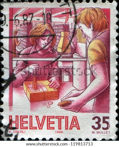 SWITZERLAND - CIRCA 1986: A stamp printed in Switzerland shows Office counter clerk, Post Past and Present series,  circa 1986