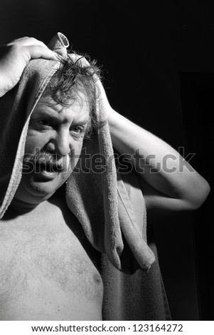 middle-aged man with a towel out of the bathroom