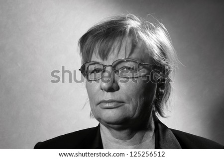 black and white portrait of middle aged woman in eyeglasses