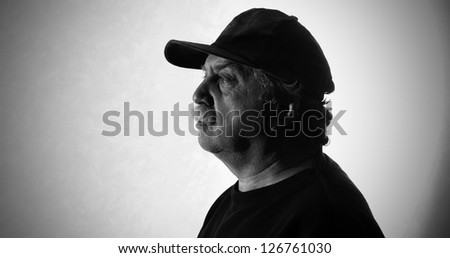 man in a baseball cap, black and white