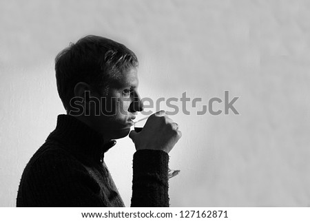 young man drinking wine, black and white