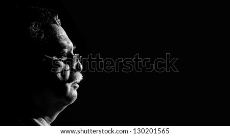 profile middle-aged man with glasses  on black background