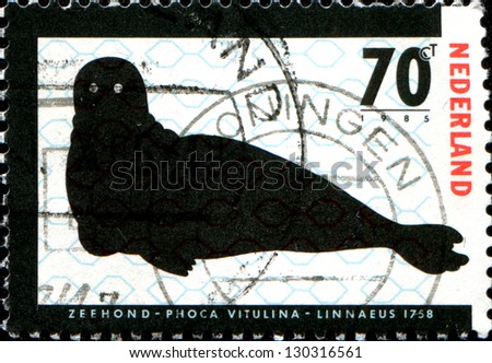 NETHERLANDS - CIRCA 1985: A stamp printed in  Netherlandsshows Endangered Animals. Seal and PCB molecule structure, circa 1985