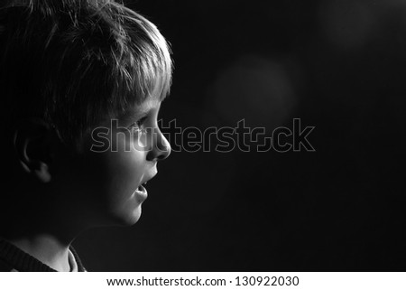 little boy looks ahead, black and white