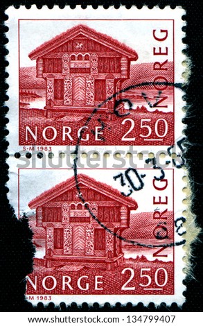 NORWAY - CIRCA 1983: A stamp printed in Norway shows wooden log house built in 1975 in Breiland, circa 1983