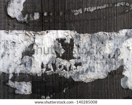 traces of the old paper-based ads on a wooden board