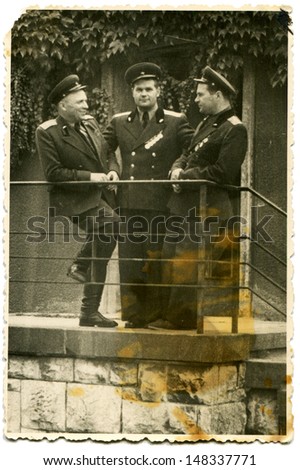 USSR - CIRCA 1960s: Vintage photo shows three officers of the Soviet Army\'s stand on the porch, 1960s