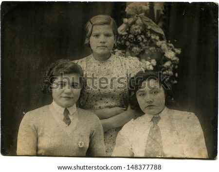 USSR - CIRCA 1930s: Vintage photo shows studio portrait of three girl friends, 1930s