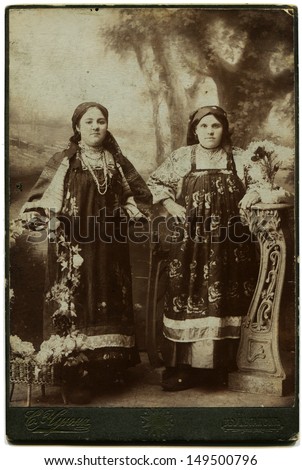 LUGANSK, RUSSIAN EMPIRE - CIRCA 1900s: Studio portrait of two women in russian national dress, photosudio by S. Chuyun, Lugansk, Ukraine, 1900s